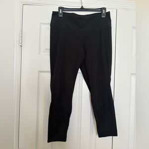 Used Fit 2 Run black leggings size large. Mesh cutout near the calf.